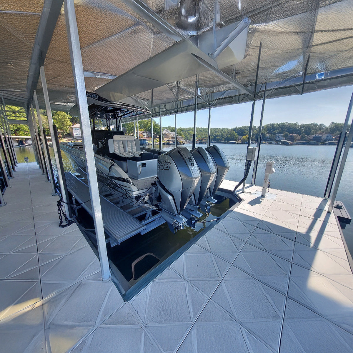 Boat on a dock with a covered area, water in the background
