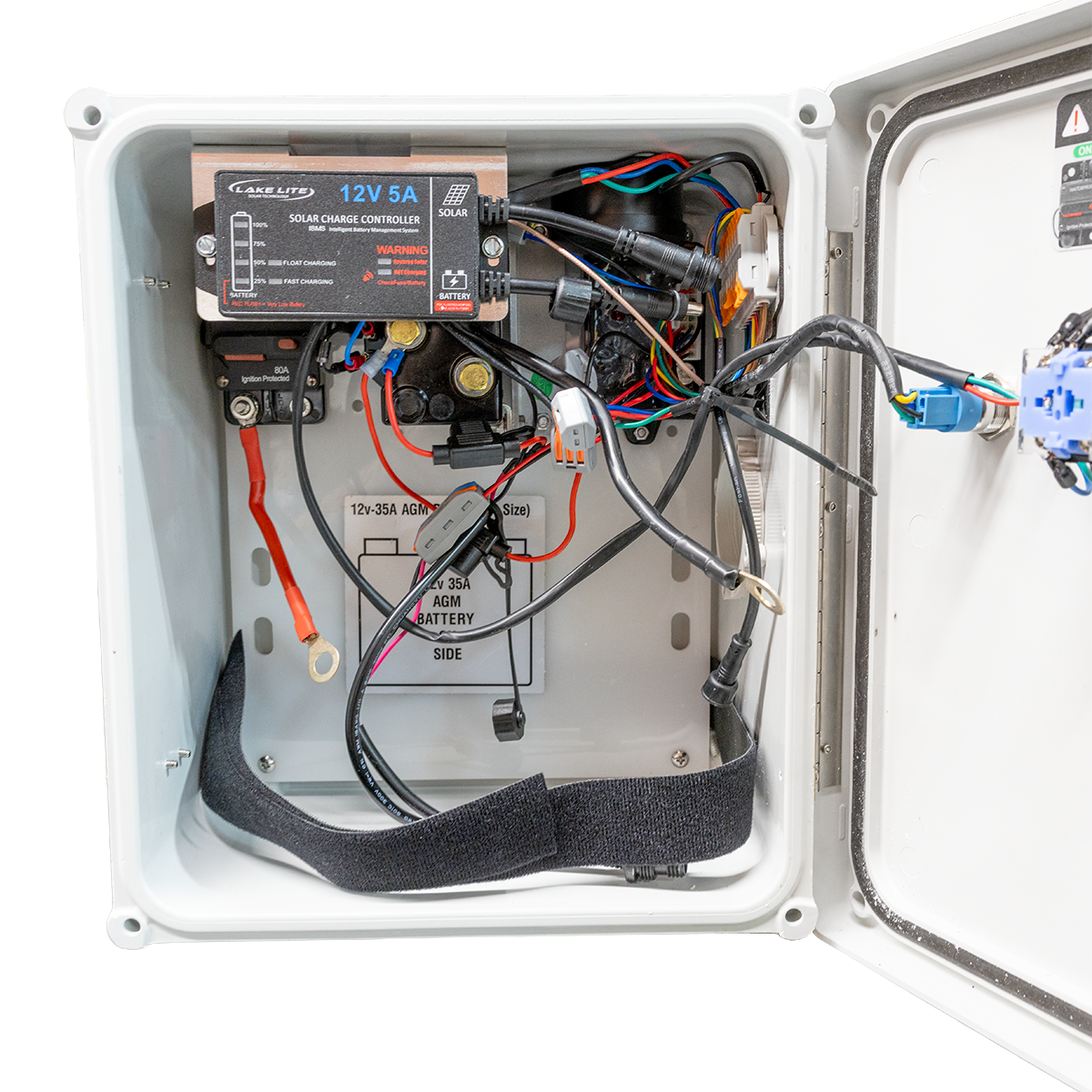 Electrical panel with wiring and a solar charge controller inside a white box.