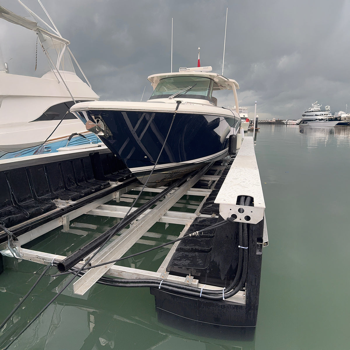 Boat on a lift at a marina with cloudy sky