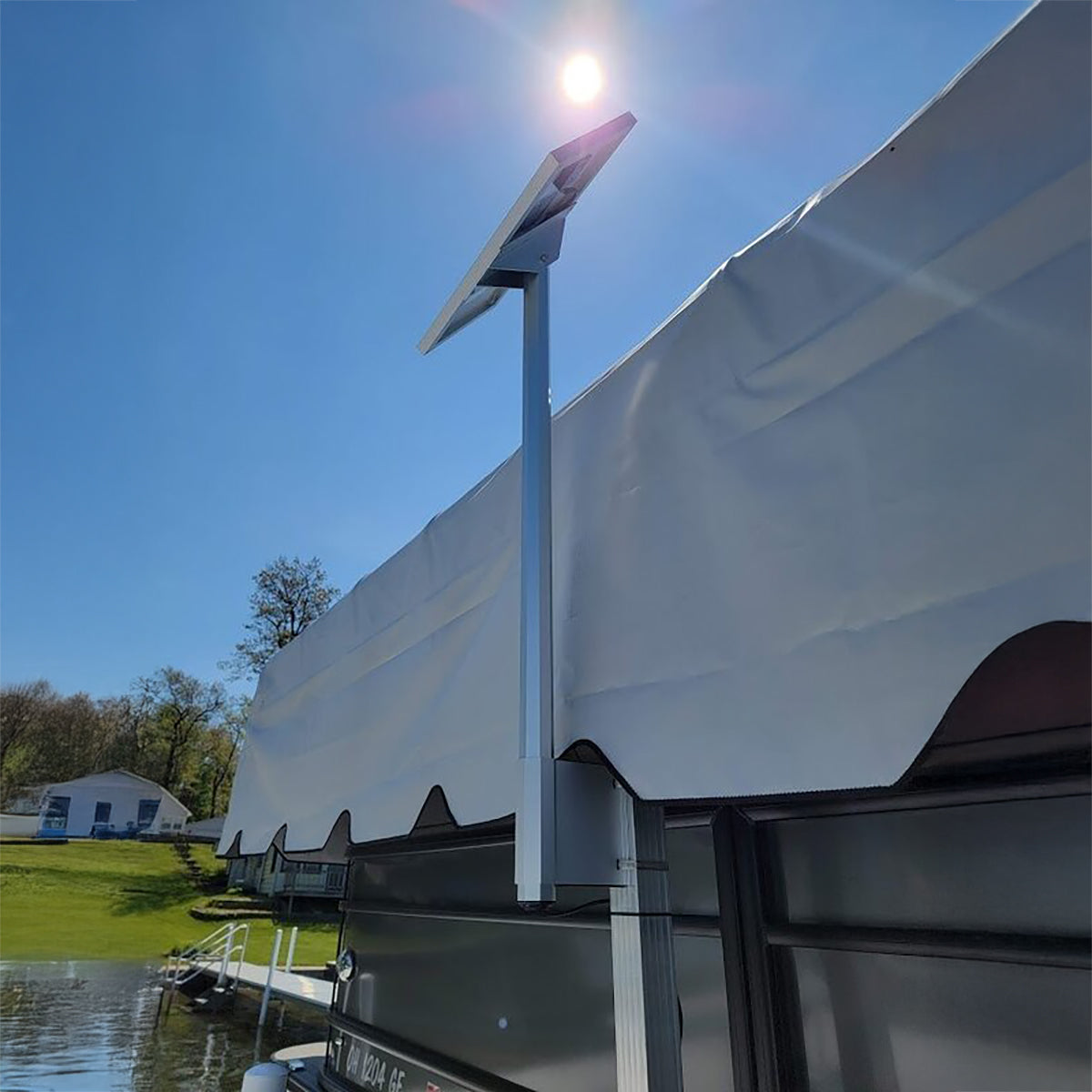 Solar panel on a boat with a clear blue sky and water in the background