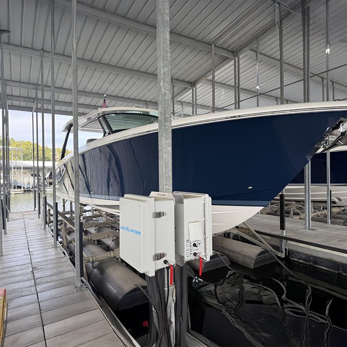 Boat being lifted by a hydraulic lift in a covered storage area