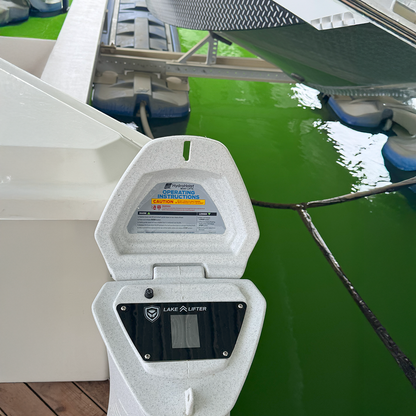 Lake Liftier boat lift system with green water and dock in the background