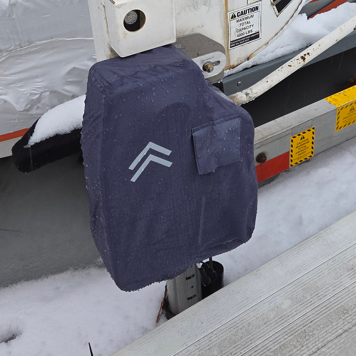 Navy blue cover with a logo on a snow-covered vehicle